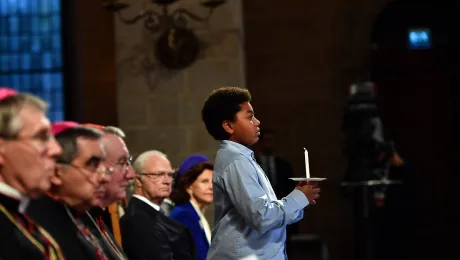 Five candles were lit by children to symbolize five joint commitments to grow in communion. Credit: Magnus Aronson/Ikon