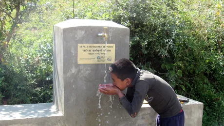 A child quenches his thirst from a water tap installed by LWF and HURADEC in Pattitar, Nepal. Photo: LWF/ M. Timsina