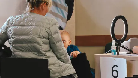 A woman and her son register at the enrolment stations in the Gdansk refugee center. Photo: LWF/ Krysztof Tylicki