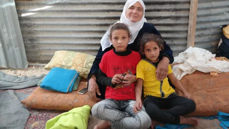 Salam (left, in red T-Shirt) with her grandmother and younger sister in their shelter in Zaâatari camp. Photo: LWF Jordan/D. OdÃ©n