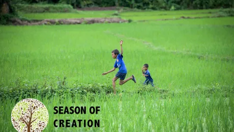 Children play in a rice field in Laos. Photo: LWF/Thomas Lohnes