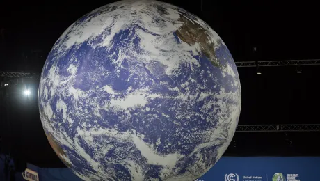 A large globe hanging from the ceiling in the Action Zone of COP26 in Glasgow last November as world leaders gathered to negotiate a response to climate crisis. Photo: LWF/Albin Hillert 