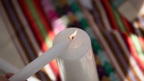 Lighting a candle during a âPrayer for the Rainforestâ as part of the Cumbre Social por el Clima, during COP25 that took place in Madrid, Spain, in 2019. Photo: LWF/Albin Hillert