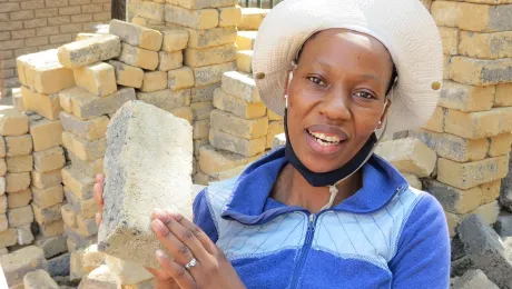 Bricklayer Makhatutu Siimane, showing what she can do with bricks. Photo: Outreach Foundation