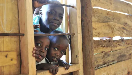 Children looking by a window at the Katalyeba Early Learning Center, in Rwamwanja, Uganda. The center welcomes children from both the host community and the refugee settlement. Photo credit: LWF/M. Renaux