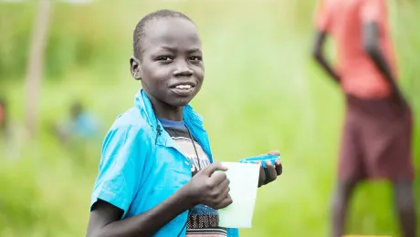 A young South Sudanese refugee eats porridge in Northern Uganda. Photos:LWF/Uganda