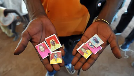 A refugee hold images of family members killed in the South Sudan conflict, Njumanzi reception center, Adjumani, Uganda. Photo: LWF/ M. Renaux