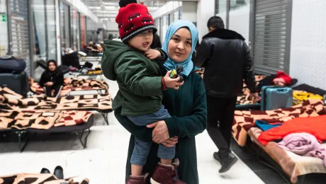 The vast majority of refugees fleeing across the Ukrainian border into Poland are women and children, including this mother and her young son. Photo: Filip BÅaÅ¼ejowski