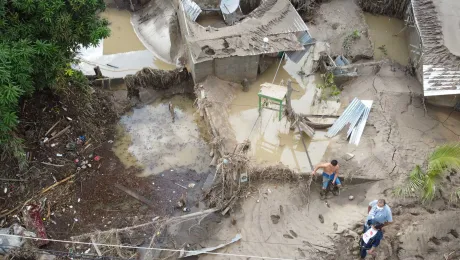 Extreme weather events: LWF representative Carlos Rivera (with white face mask) visiting ChamelecÃ³n, Honduras, where many homes were washed away in unexpected flooding from the hurricanes Eta and Iota in 2020. Photo: LWF/Sean Hawkey