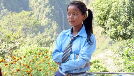 Sanu in her school uniform. The prospect of higher education prompted her to find a way of attending school, even though school is a day's walk from home. Photo: Umesh Pokharel/LWF Nepal