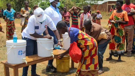 Hand washing before a distribution in Burundi. Water is essential to proper hygiene and to prevent the spread of COVID-19. Photo: LWF Burundi