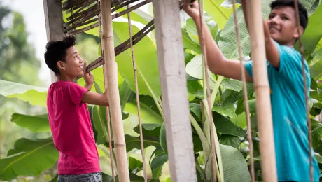 Two young men construct a house in the Beldangi Refugee Camp in southeast Nepal. Photo: LWF/Albin Hillert