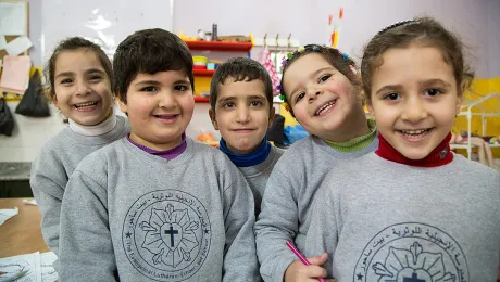 Students from the kindergarten of the Evangelical Lutheran School in Beit Sahour take a break from learning their Arabic alphabet to pose for a photo. Photo: ELCJHL