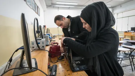 21 January 2023, Ramallah, Palestine: 19-year-old telecommunications student Reham Rajh (right) from Ramallah is at work during a class taught by Anas Shtaya (left) at the Lutheran World Federation’s Vocational Training Centre in Ramallah. The centre currently hosts 141 students across eight different training programmes. This school year, 85 of the students are female. Photo: LWF/ Albin Hillert