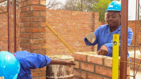 Nomathemba Sibanda displays her masonry skills at the public works site in Filabusi town, southern Zimbabwe. Photo: LWF/Monmo Dahiru Moodi