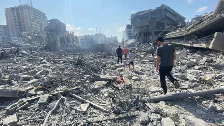 Palestinians walk among the rubble caused by an Israeli airstrike on Gaza City. Photo: Wafa / APAImages (CC-BY-SA)