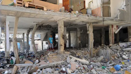 A Palestinian resident walks amongst the rubble of a destroyed building in Gaza. Photo: UN Photo/Shareef Sarhan