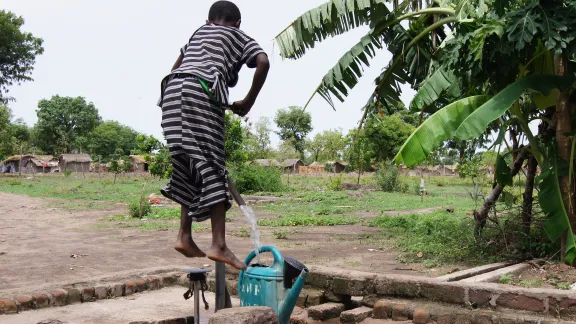  A young boy pumps water from well and into his watering can in Chad.  Photo: LWF/C. KÃ¤stner