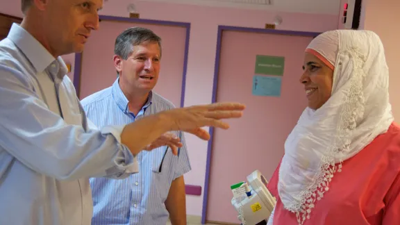 (left to right) LWF General Secretary Rev. Martin Junge and Rev. Mark Brown, LWF/DWS Middle East Program representative, talk with AVH pediatric nurse Shadja Nasser. Â© LWF/Thomas Ekelund