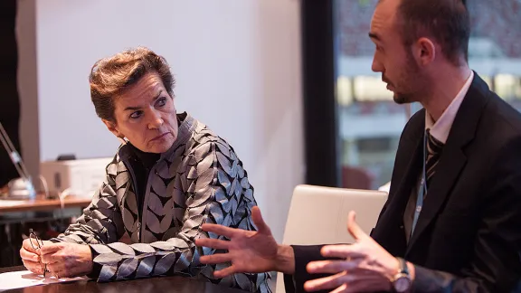 Martin Kopp (right), LWF delegate to the UN Climate Conference (COP19), speaks with Christina Figueres, director of UN Framework Convention on Climate Change. Photo: LWF/ Sean Hawkey