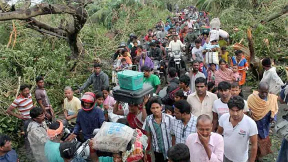 Villagers returning to their homes after Cyclone Phailin. Photo: LWSIT