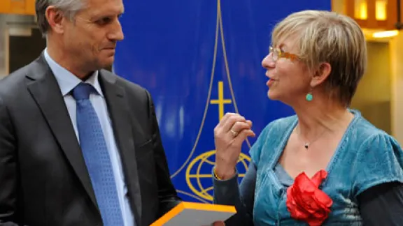 (right) equal-salary Executive Director VÃ©ronique Goy Veenhuys awards the equal wage certification label to LWF General Secretary Rev. Martin Junge. Â© LWF/H. Putsman Penet