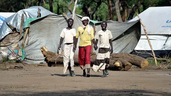 Haram Jukin (center) walks with two of her friends in Yusuf Batil refugee camp in South Sudan's Upper Nile State. Â© Paul Jeffrey