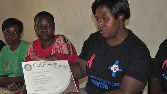 A member of the ELCZ Mufakose parish self-help group shows her recently acquired skills-training certificate. Â© LWF/Stanley Kwenda