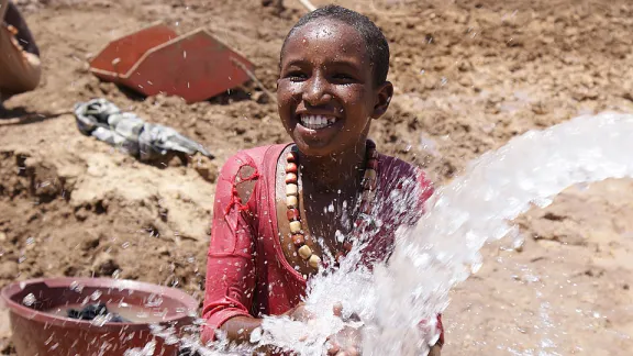 A splash of fresh water from a newly constructed borehole at Teferi Ber refugee camp, Ethiopia. Â© LWF/R. Bueno De Faria