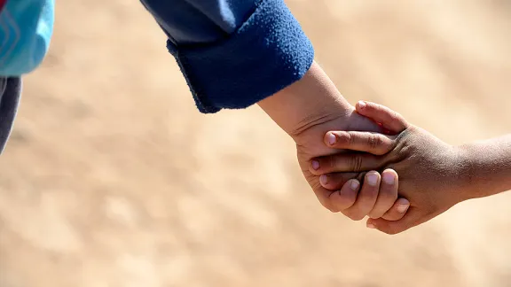 Children holding hands in the Za'atri refugee camp. The LWF is present in Jordan supporting Syrian refugees with winter clothing, winterization of tents, prefabricated container houses and psychosocial support. Â© Magnus Aronson