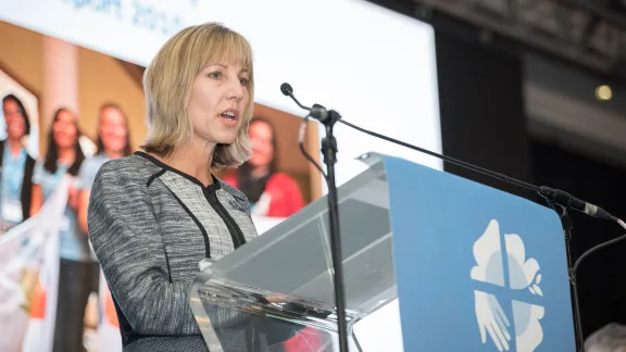 Christina Jackson-Skelton giving the report of the Finance Committee at the Lutheran World Federation's Twelfth Assembly. Photo: LWF/Albin Hillert