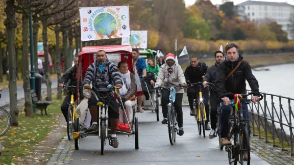 The statement was delivered by faith leaders on bicycles, promoting sustainable lifestyles. Photo: WCC/Sean Hawkey.