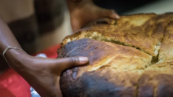 Traditionally baked Ethiopian bread being shared out with participants at a global consultation on Lutheran identities in Addis Abeba in October 2019. Photo: LWF/Albin Hillert