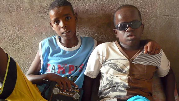 Blind but not illiterate: Mahomed, right, is blind but intelligent and learns about the world through the radio his brother holds. Photo: ALWS/Jonathan Krause