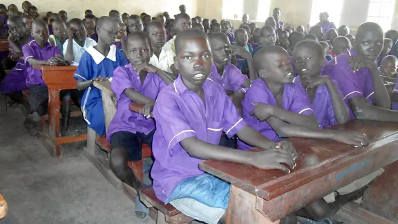 Emmanuel sits in class, supported by the LWF and safe from the violence he fled in South Sudan. Photo: LWF Uganda