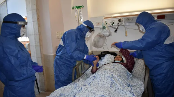 DrÂ  AliÂ Sabateen, whoÂ isÂ head of infectious diseases unit and of the Coronavirus Center, comforts a patient at Augusta Victoria Hospital, Jerusalem. Photo: LWF/AVH/EzdiharÂ Shaheen