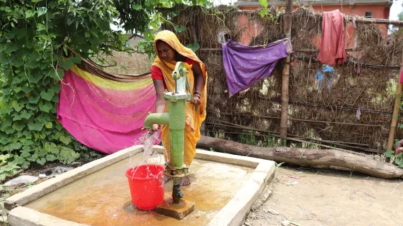 Ms. Rohini Devi Paswan, a resident of Dhanusa, drawing water from a newly constructed hand pump â Photo credit: Suman Rai/LCWS