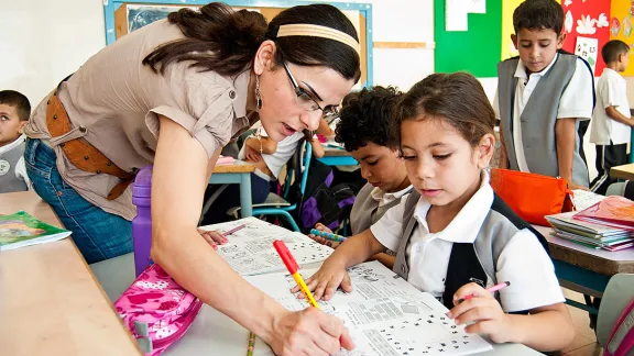 A teacher and students at Dar al-Kalima Evangelical Lutheran School in Bethlehem, West Bank. Photo: ELCJHL/Elizabeth McHan