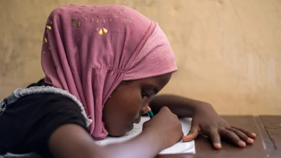 A girl from Somalia studies in an LWF primary school, Ali Addeh camp, Djibouti. LWF strongly advocated for girlâs education and against early marriage. Photo: LWF/ HelÃ©ne WikstrÃ¶m