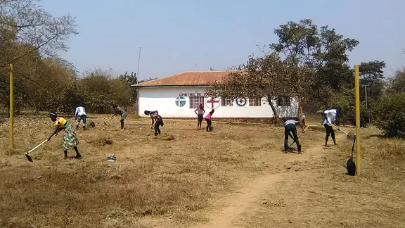 EELCO youth clear church grounds where new trees will be planted. Photo: Cedrick Y. Kitwa