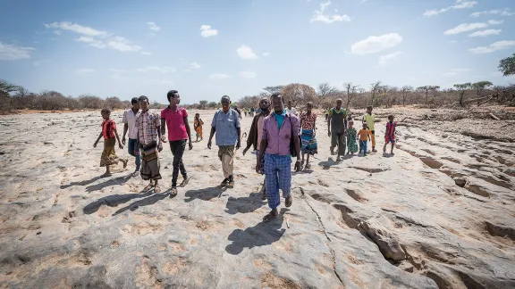  A group of Oromo IDPs walk on the dry riverbed near Burka Dare IDP site in Ethiopia. The Lutheran World Federation supports internally displaced people in several regions of Ethiopia, through emergency response on water, sanitation and hygiene (WASH) as well as long-term development and empowerment projects, to help build resilience and adapt communitiesâ lifestyles to a changing climate. 27 January 2019. Photo: LWF/Albin Hillert