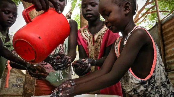 Children demonstrate hand washing at Kakuma refugee camp, Kenya. The LWF is the main implementer of education in the camp, and awareness-raising on hygiene is part of that work. The LWF has reinforced hygiene education to prevent the spread of COVID-19 in the camp. Photo: LWF/P. Omagwa