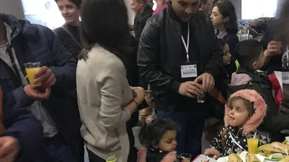 A volunteer welcomes 40 people from Lebanon at Charles de Gaulle airport on Monday, January 29, 2018. Families and individuals will be living in different regions, depending on reception possibilities. Photo: Jean-Michel Hitter/FEP