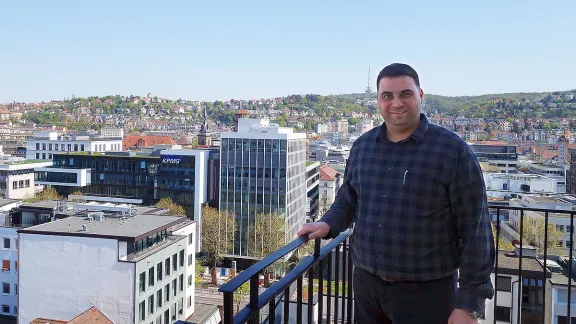 Adam Gnany, verger at the Hospitalkirche, at the roof of the church enjoying the wonderful view over Stuttgart. Photo: EMH/Ute Dilg