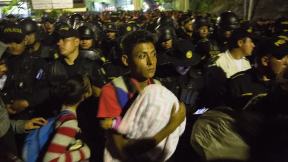 A father carries his baby at the Aguas Calientes border post between Honduras and Guatemala, close to a military roadblock. No undocumented migrant was allowed out of Honduras or into Guatemala, and anyone with an arrest warrant on either side of the border was taken into custody. Photo: LWF/Sean Hawkey