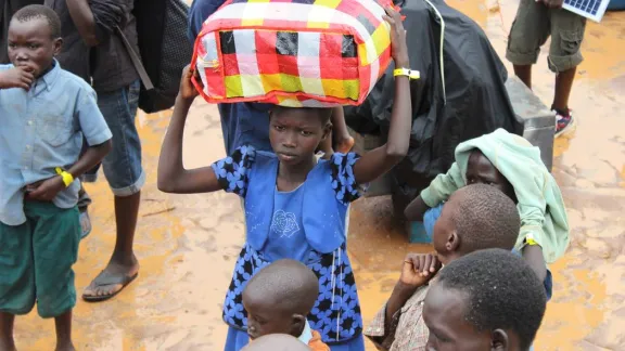 A child arrives arrives at the Elegu collection point on the South Sudan-Uganda border with what she can carry. Photo: LWF/P. Kikomeko 