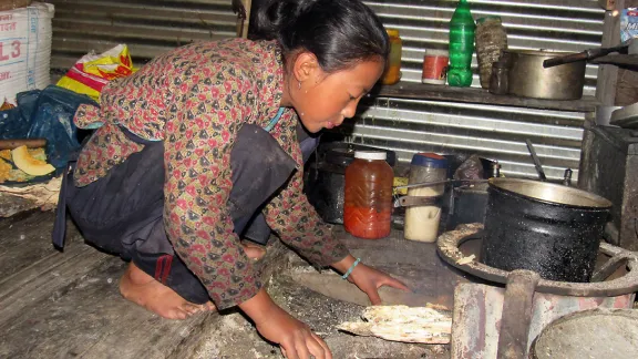 Nima Chhiyog Lama, 13, a seventh grader in Gatlang prepares food and takes care of her siblings before school. Surviving the earthquake is like being given a second life, she says. Photo: LWF Nepal