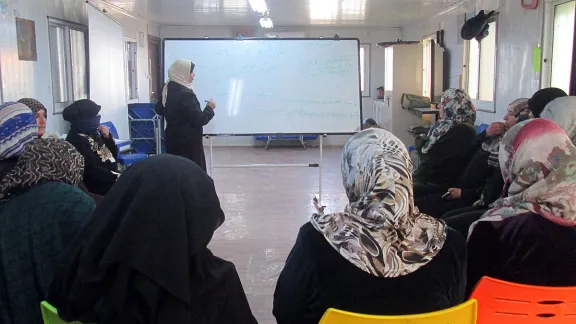 Wafeh shares her knowledge in the womenâs group. Photo: LWF/N. Boase