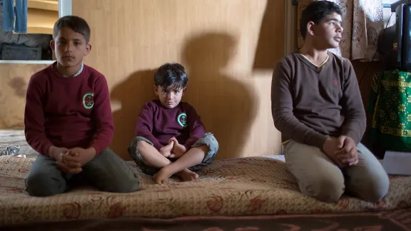 One half of all refugees at the Za'atari Camp are children. Three brothers from a Syrian family sit, hoping for an end to the conflict.  Photo: LWF/Maria de la Guardia 