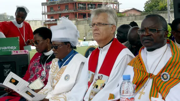 From the right: Bishop Dr Jensen Seyenkulo of the Lutheran Church in Liberia;  LWF General Secretary Rev. Dr Martin Junge; LWF Vice-President for Africa, Rev. Dr Jeannette Ada Maina, Evangelical Lutheran Church of Cameroon; and the Africa region area secretary, Rev. Dr Elieshi Mungure, during the ecumenical worship service at the Antoinette Tubman Stadium in Monrovia, Liberia. LWF/Felix  Samari